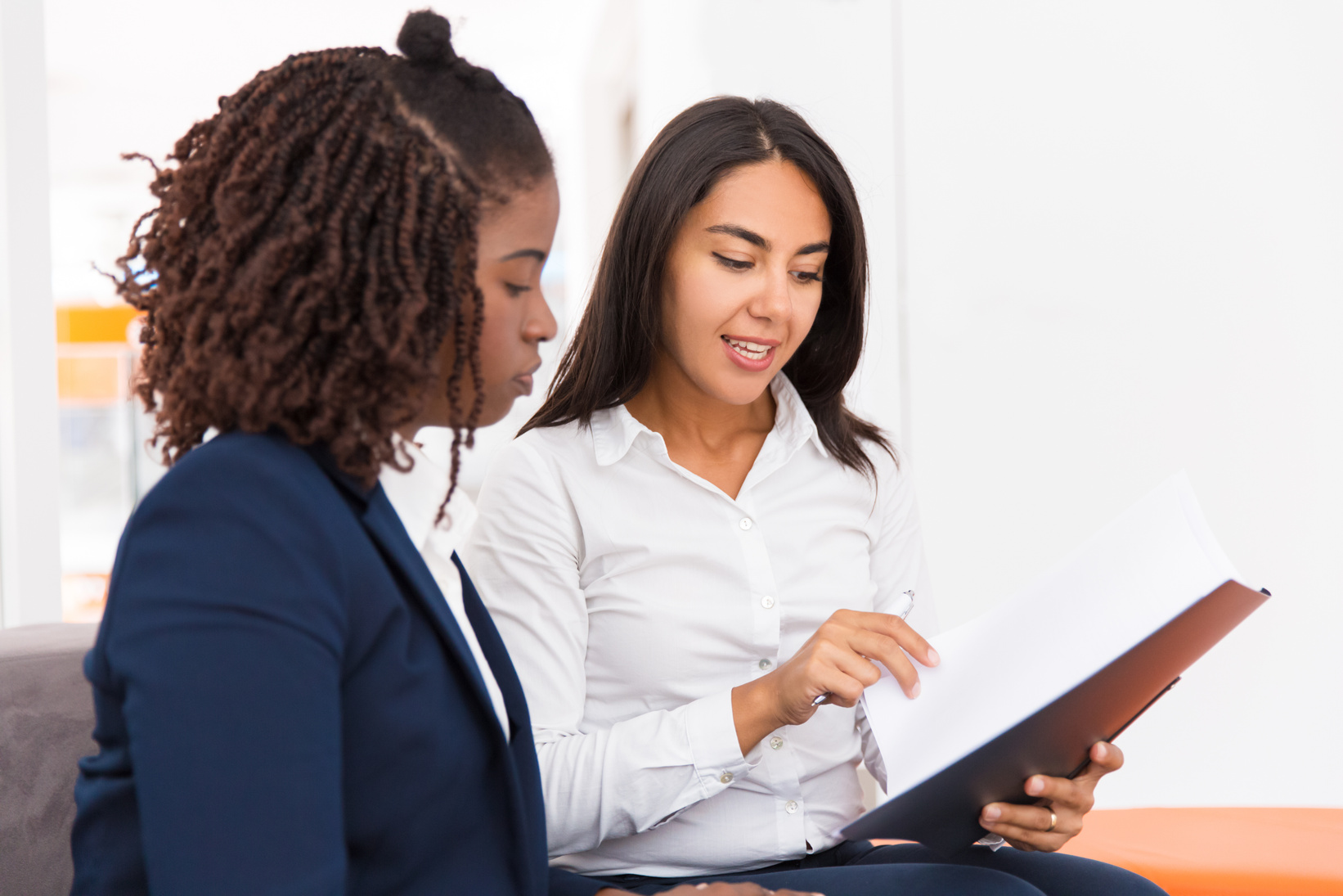 Confident female legal consultant explaining document specific